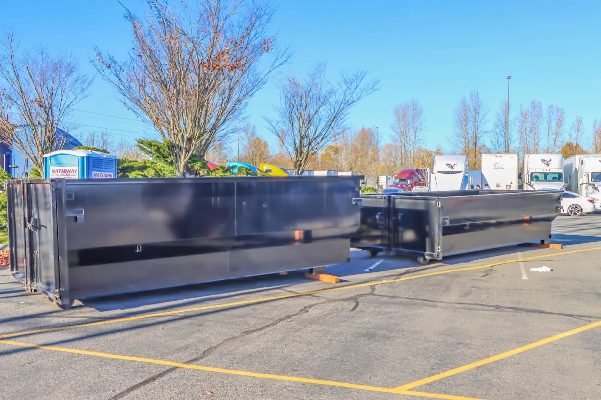 Professional dumpster rental service with roll-off container on residential driveway in Verdigris